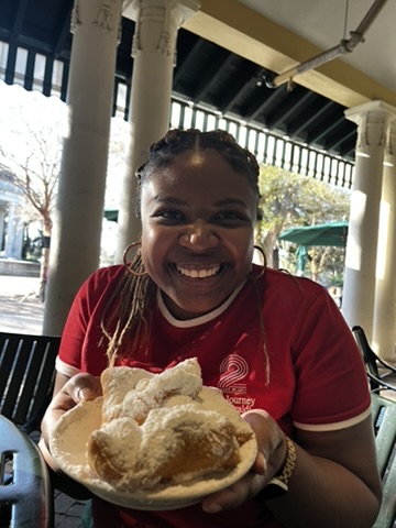 Alex with beignets in New Orleans